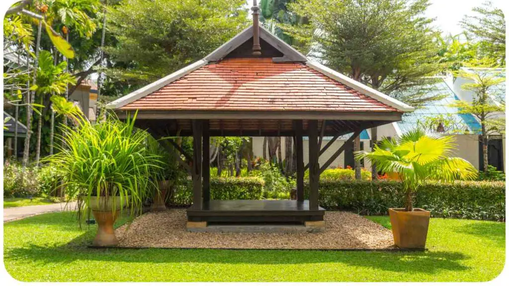 a small gazebo in the middle of a lush green yard