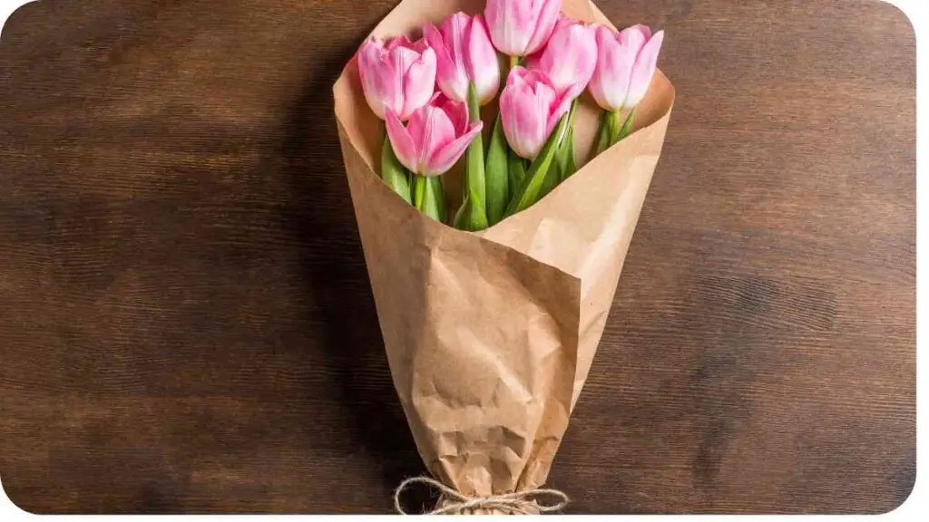a bouquet of pink tulips in a brown paper bag