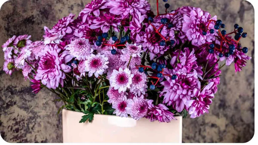 a bouquet of purple flowers in a white vase