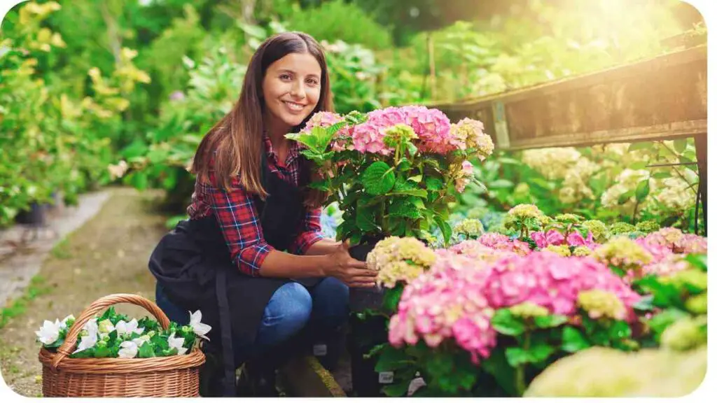 a person is holding a basket of flowers in a garden