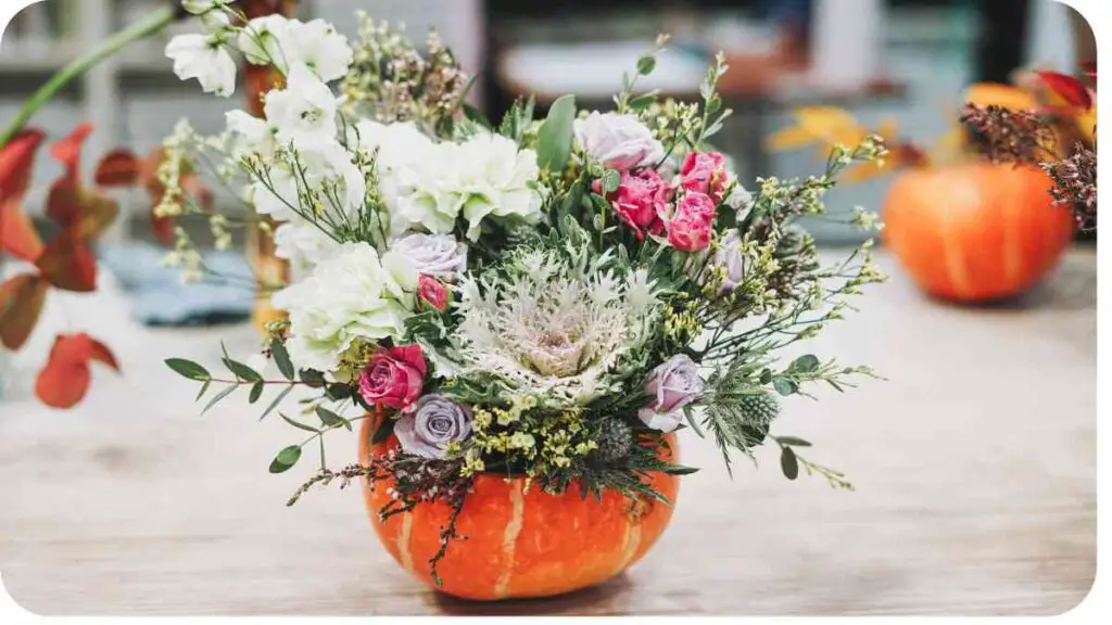 flowers in a pumpkin vase on a table