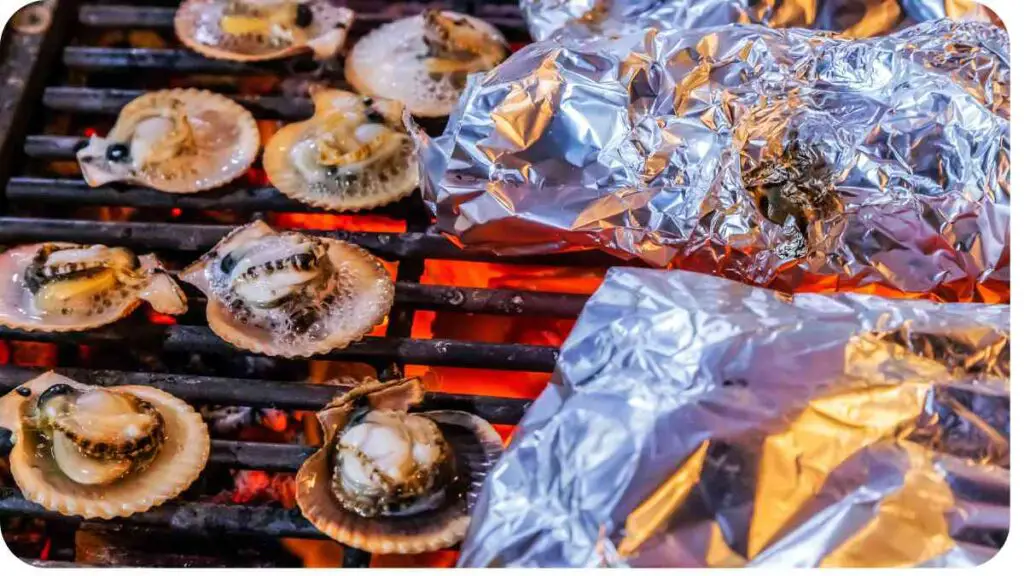 scallops on a grill with foil wrapped around them
