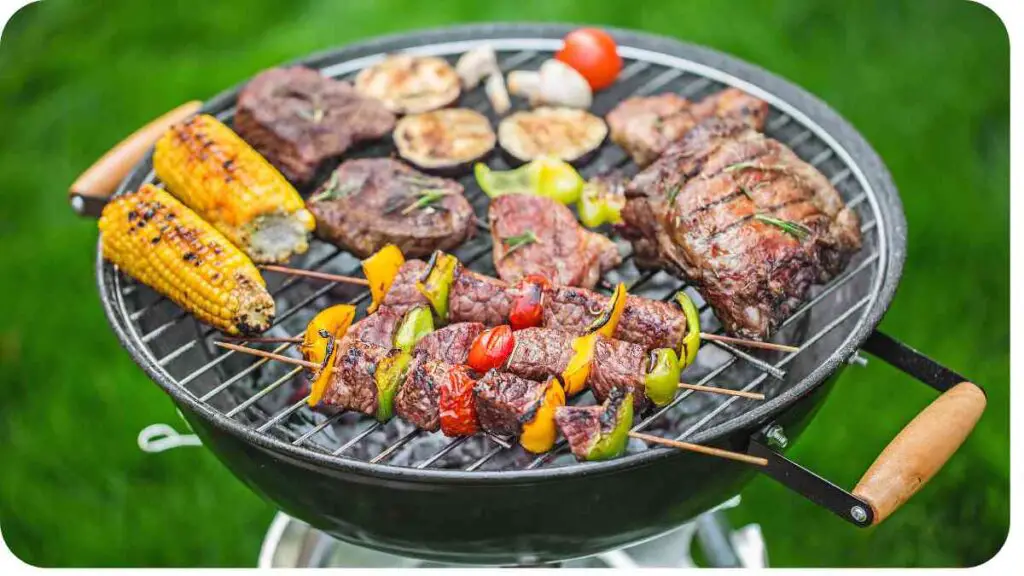 a barbecue grill with meat and vegetables on it