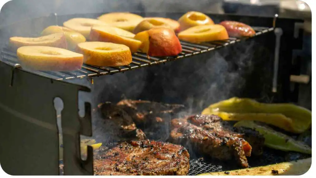 steaks and apples on a grill with smoke coming out of it