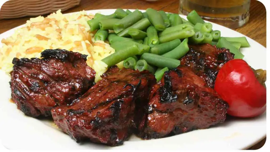 a white plate topped with meat and green beans
