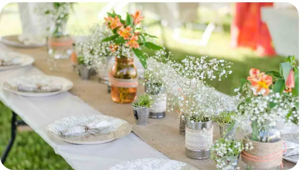 a long table with white plates and vases filled with flowers