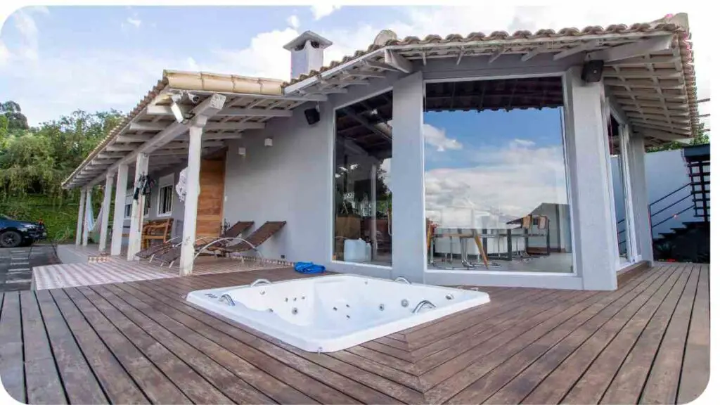 a wooden deck with a hot tub in front of a house