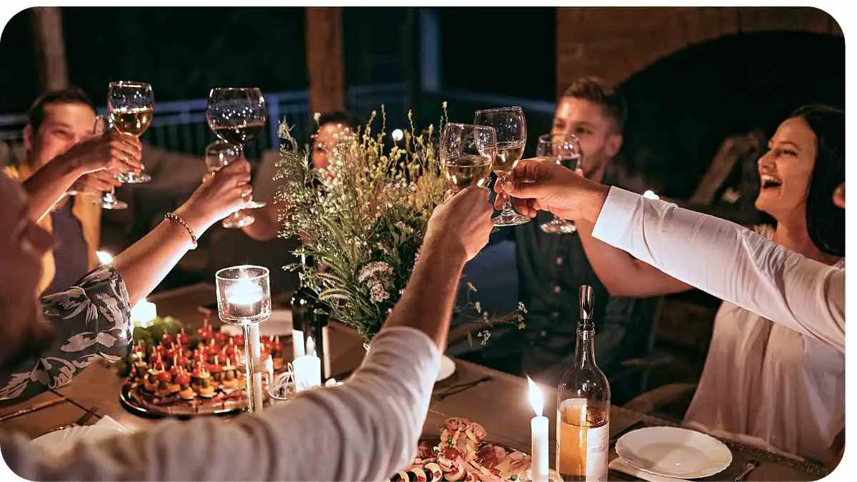 a group of people toasting at a dinner party
