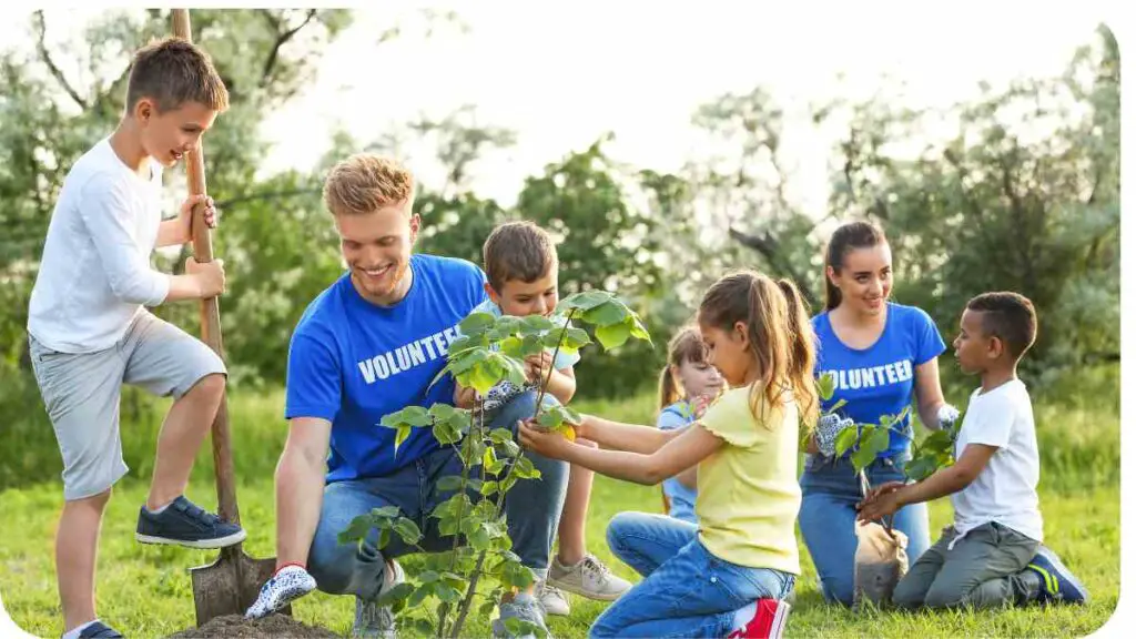 a group of children and adults planting trees