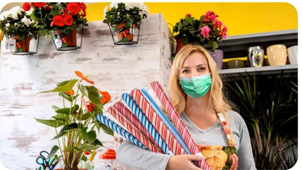 a person wearing a face mask and holding a bunch of flowers