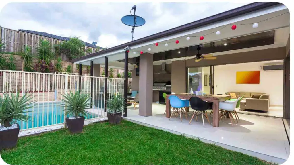 an outdoor living area with a pool and dining table