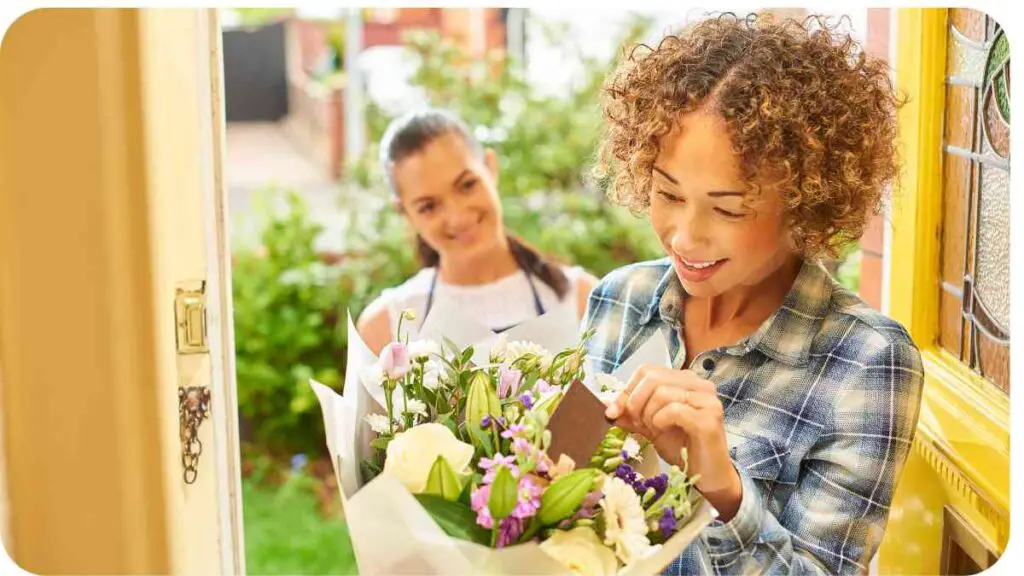 A person holding a bouquet of flowers in front of a door.