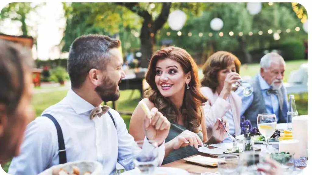 a group of people sitting at an outdoor dinner table